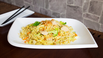 Asian combo plate with chicken and vegetables served with rice.