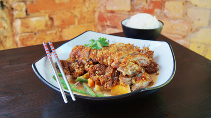 Dish with crispy duck in a restaurant in China. Asian combo plate with and vegetables and rice.