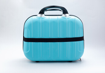 Small blue travel bag with handle, large cloth baggage case. Modern suitcases for traveling. Luggage isolated on white background with copy space. Travel summer holidays, tourism, vacation concept