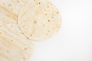 Mexican plain wheat tortilla wraps on white background, copy space