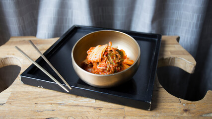Bowl with kimchi salad. Kimchi is a Korean dish made from a fermented preparation whose basic ingredient is Asian cabbage or Brassica pekinensis cabbage.