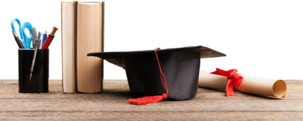Black graduation cap with books and diploma on desk