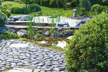 Japanese garden with stone path and pond