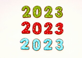 Colorful Gingerbread cookies in the form of numbers 2023  on a white background. New year concept. Top view. Copy space