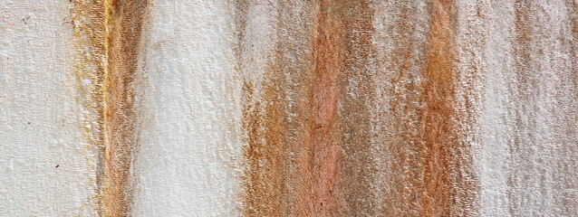 Orange and Brown Streaks on a Pale White Plaster Wall. Rustic background.