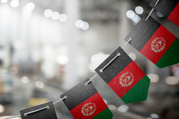 A garland of Afghanistan national flags on an abstract blurred background