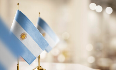 Small flags of the Argentina on an abstract blurry background