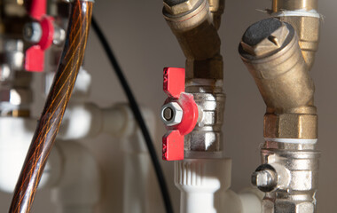 Fototapeta na wymiar Gas heating system with red taps.