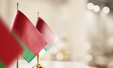 Small flags of the Belarus on an abstract blurry background
