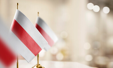 Small flags of the Belarus on an abstract blurry background