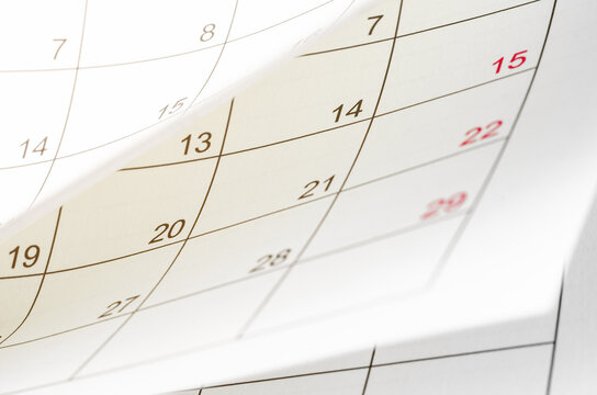 A Calendar page flipping sheet close up blur background business schedule planning appointment meeting concept