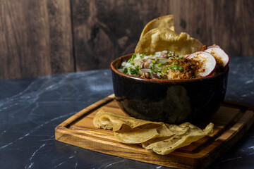 mexican food meat bowl, with meat juice cilantro and onion on the cover, mexican wooden plates