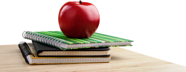 School teacher's desk with stack of books and apple
