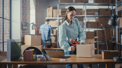 Stylish Storeroom Worker Preparing a Small Parcel for Postage. Inventory Manager Taping a Cardboard Box Before Shipping It to Customer. Female Small Business Owner Working in Warehouse Facility.