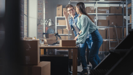 Portrait of a Successful Young Small Business Owner Smiling, Looking at Camera. Caucasian Male Holding a Cardboard Box in a Warehouse Storeroom with Orders Ready for Shipment.