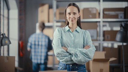 Soft Portrait of an Empowering Attractive Caucasian Female Looking at Camera, Working in Warehouse Storeroom of an Online Store. Successful Young Smiling Small Business Owner.