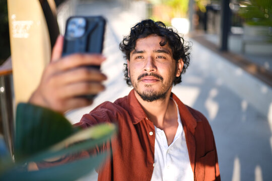 Smiling man taking a selfie with his mobile phone