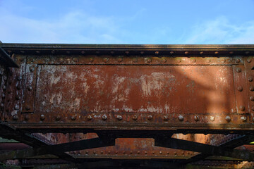 Old rusty metal structure with rivets, bridge detail.
