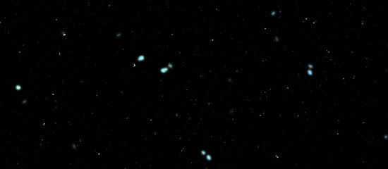 Snowfall bokeh on dark foundation. Numerous snowflakes in flying in the air. Winte night snowfall and snowstorm of snow at. Obscure bokeh light impact innovative foundation.