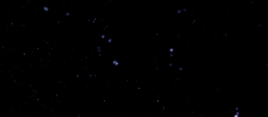 Fototapeta premium Snowfall bokeh on dark foundation. Numerous snowflakes in flying in the air. Winte night snowfall and snowstorm of snow at. Obscure bokeh light impact innovative foundation.