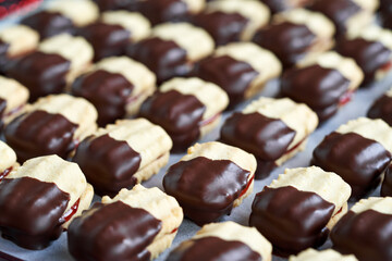 Homemade Christmas cookie filled with marmalade and dipped in chocolate
