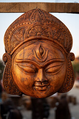Beautiful handmade wooden sculpture of Goddess devi Durga is displayed in a shop for sale in...