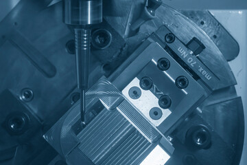 The 5-axis CNC milling machine  cutting the metal mold part.