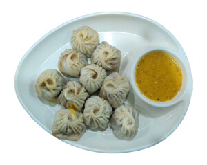 Traditional dumpling chicken momos, Plate of traditional Nepali food momos. Steam cooked momos with sauce. Nepalese traditional dumpling momos.
