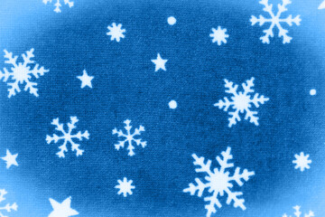 White snowflakes on blue material holiday background