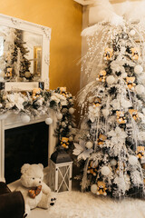 A Christmas Tree With Ornaments And Teddy Bears As Decoration. The tree is large, it is decorated with lights, tinsel, and other ornaments. 