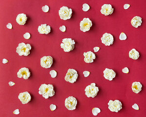 White flowers roses and white heart petals on a red paper background. Top view, flat lay