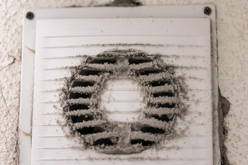 Very dirty and dusty white plastic air vent. The ventilation shaft in the apartment. Dirty air...