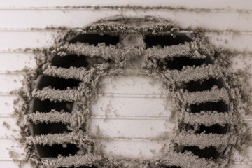 Very dirty and dusty white plastic air vent. The ventilation shaft in the apartment. Dirty air...