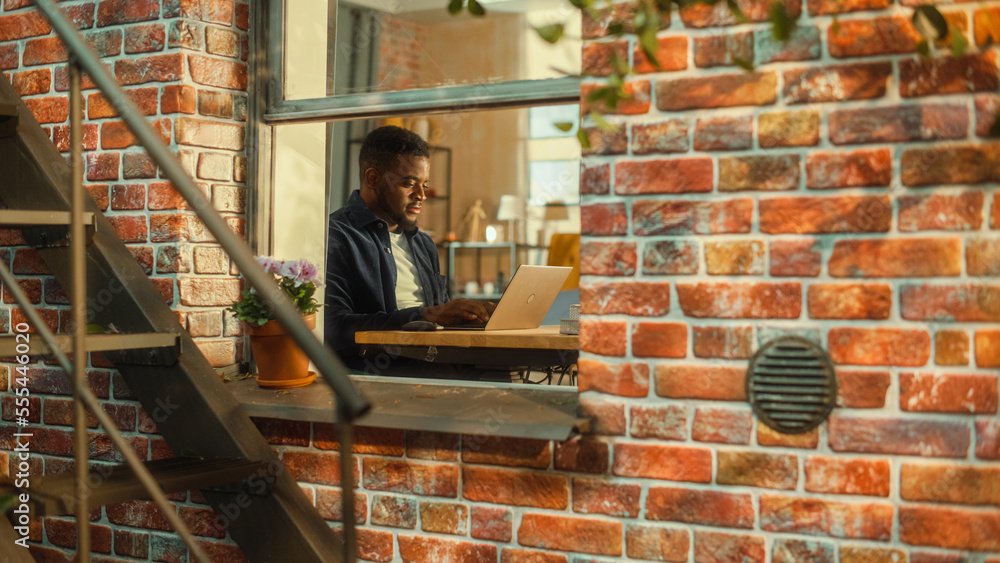 Aufkleber young black man using laptop at home. doing inspirational remote work during the day. specialist wor
