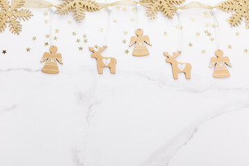 Christmas decorations in gold colors on white background. Gift, holiday and celebration concept, top view