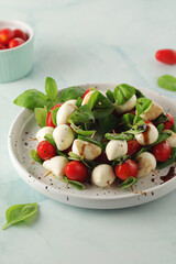 A plate with Italian salad caprese canape