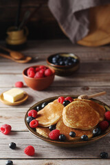 Pancakes with berries in rustic style