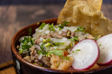 carne en su jugo mexican food, includes onion, radish, beef and corn tostadas