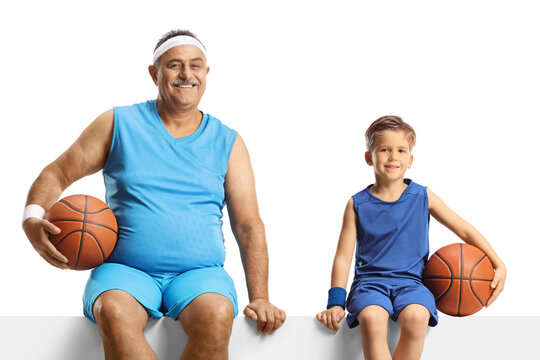 Mature Man And A Boy In Jersey Holding A Basketball And Sitting On A Blank Panel