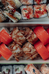 Beautiful delicious sushi. Sushi delivery. Advertising sushi rolls made of fish and cheese.