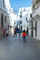 A group of boys and girls playing soccer together in the street of Tanger, Morocco