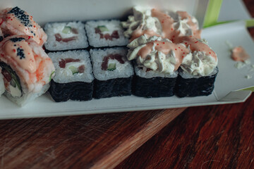 Beautiful delicious sushi. Sushi delivery. Advertising sushi rolls made of fish and cheese.