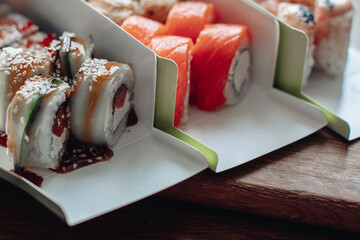 Beautiful delicious sushi. Sushi delivery. Advertising sushi rolls made of fish and cheese.