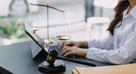 Male lawyer working with contract papers and wooden gavel on tabel in courtroom. justice and law ,attorney, court judge, concept.
