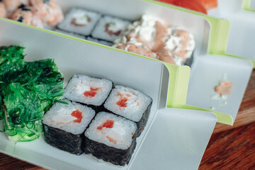 Beautiful delicious sushi. Sushi delivery. Advertising sushi rolls made of fish and cheese.
