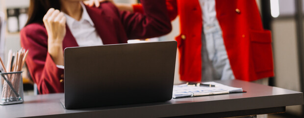Businessman and team analyzing financial statement Finance task. with smart phone and laptop and...