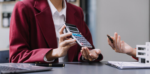 Discussion with a real estate agent, House model with agent and customer discussing for the contract to buy, get insurance or loan real estate or property.