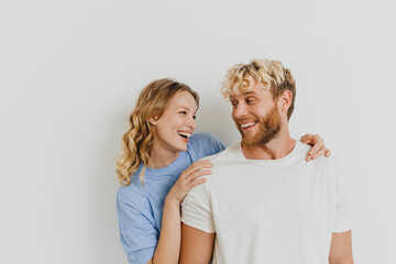 White blond excited couple laughing and hugging together