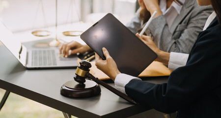 Male lawyer working with contract papers and wooden gavel on tabel in courtroom. justice and law ,attorney, court judge, concept.