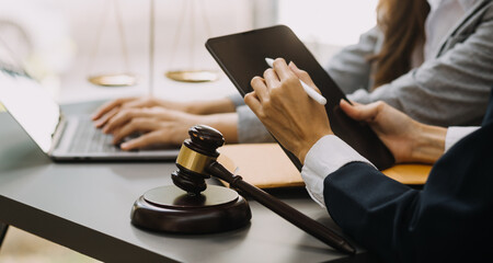 Male lawyer working with contract papers and wooden gavel on tabel in courtroom. justice and law ,attorney, court judge, concept.